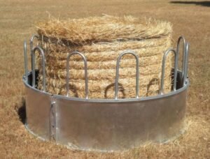 a cattle hay feeder around a bandle hay